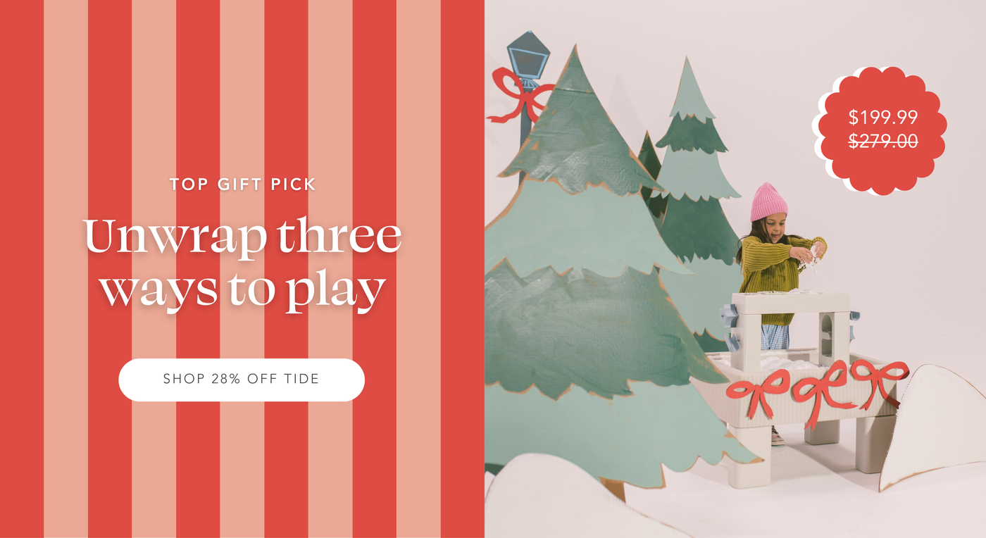 Kid playing with snowy sensory activity in Tide Table surrounded by cardboard trees and piles of snow | Top Gift Pick: Unwrap three ways to play | Shop 28% Off Tide