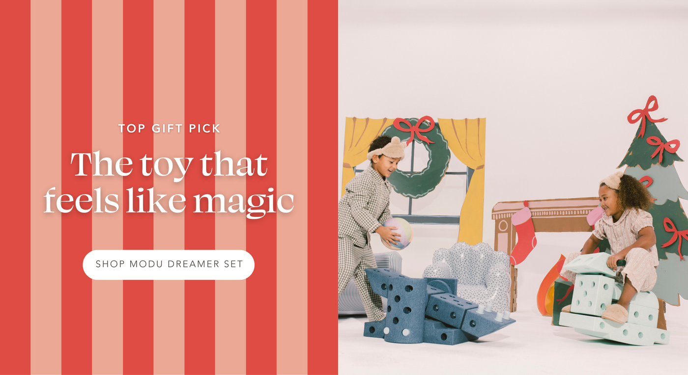 Two kids in pajamas playing with MODU Dreamer Set. One putting a ball on a toy catapult and the other rocking on a rocking horse. Top Gift Pick: The toy that feels like magic | Shop MODU